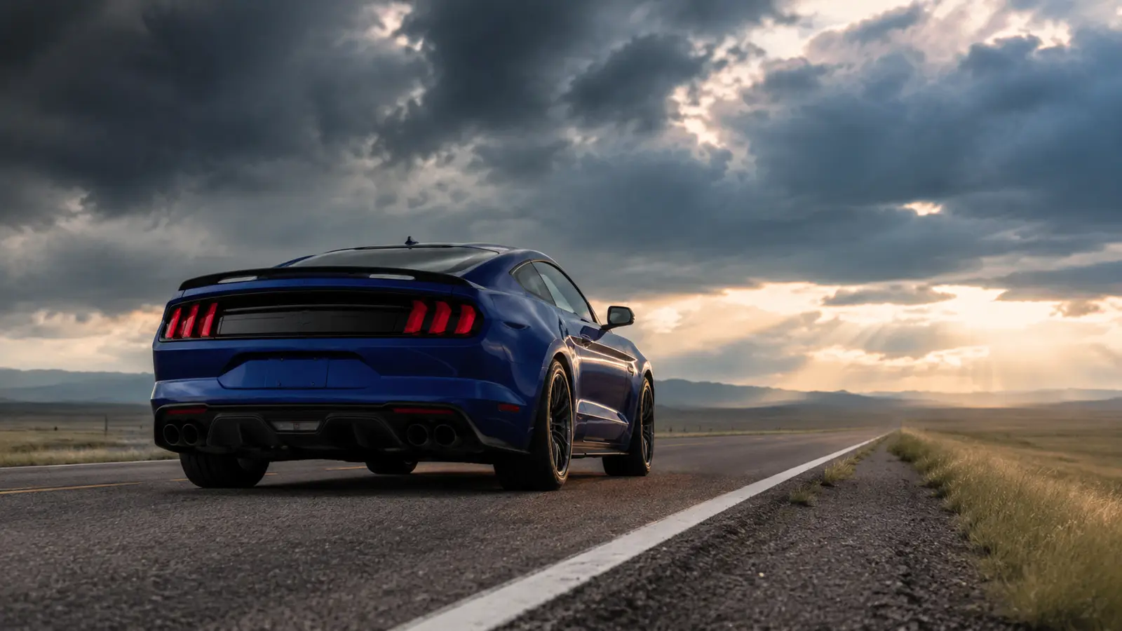 АВТО 1000692 синий Ford Mustang сзади на дороге через прерии
