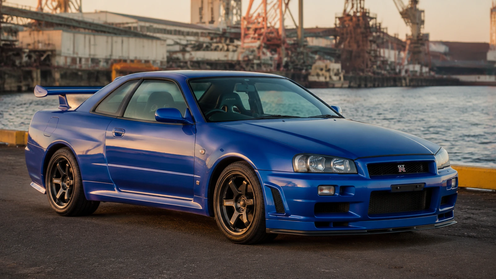 АВТО 1000708 синий Nissan Skyline R34 в промышленной гавани 90-х